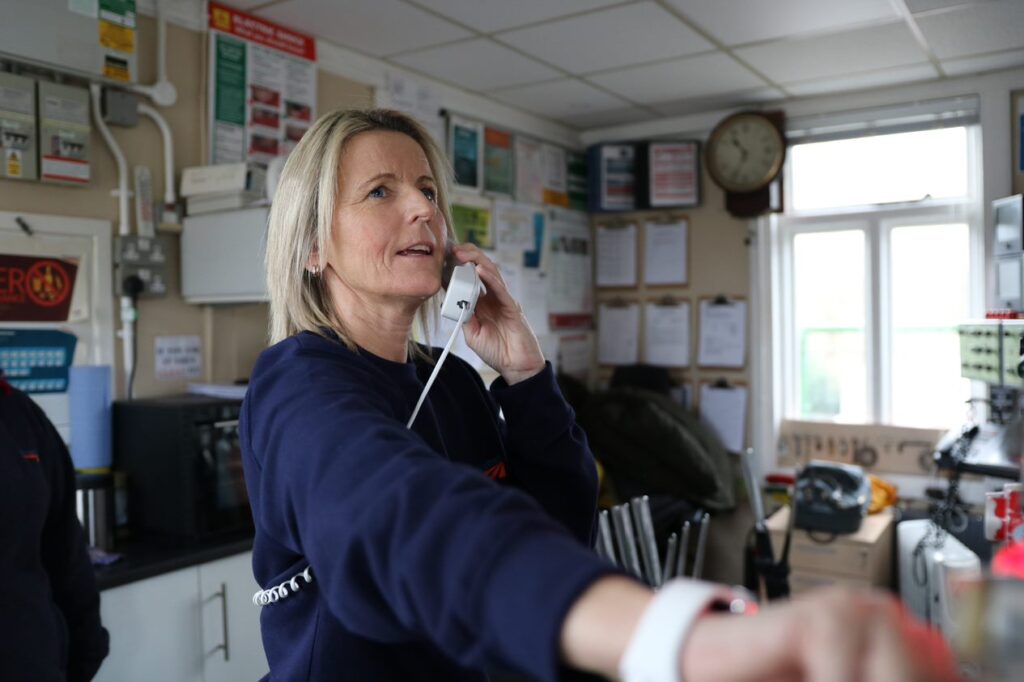 Signaller Angela Badrock on the phone in her signal box.