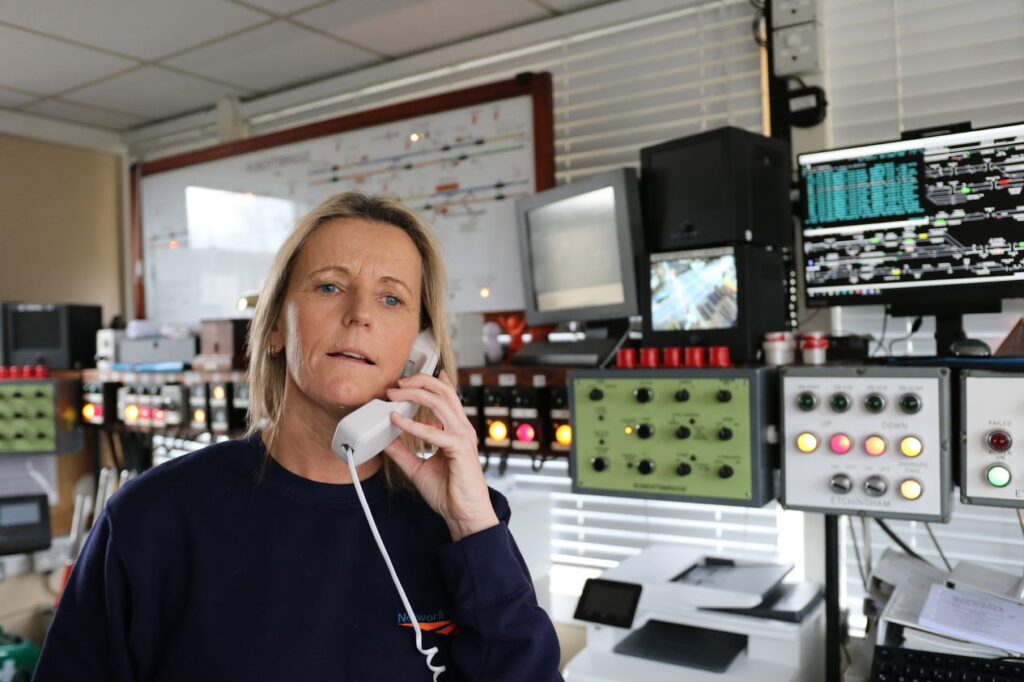Signaller Angela Badrock on the phone in her signal box.