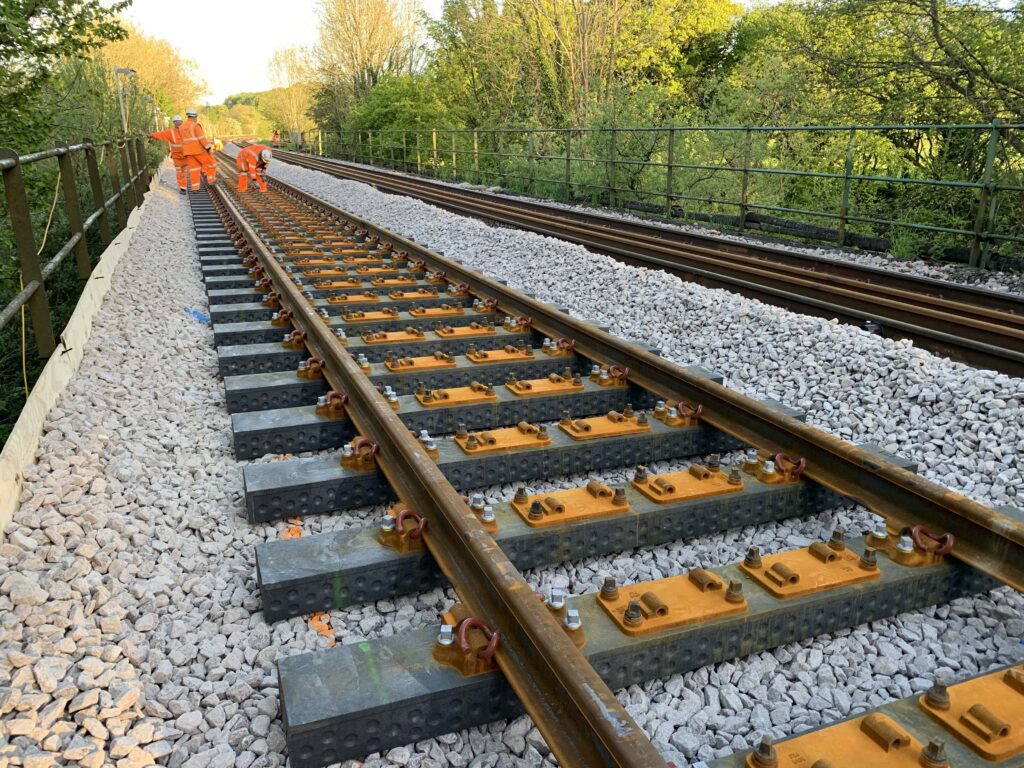 Rail workers on newly-laid track.
