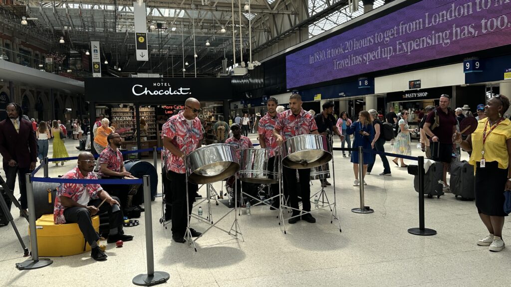 A steel band performs on the concourse of London Waterloo as part of an event marking the 75th anniversary of the Empire Windrush.