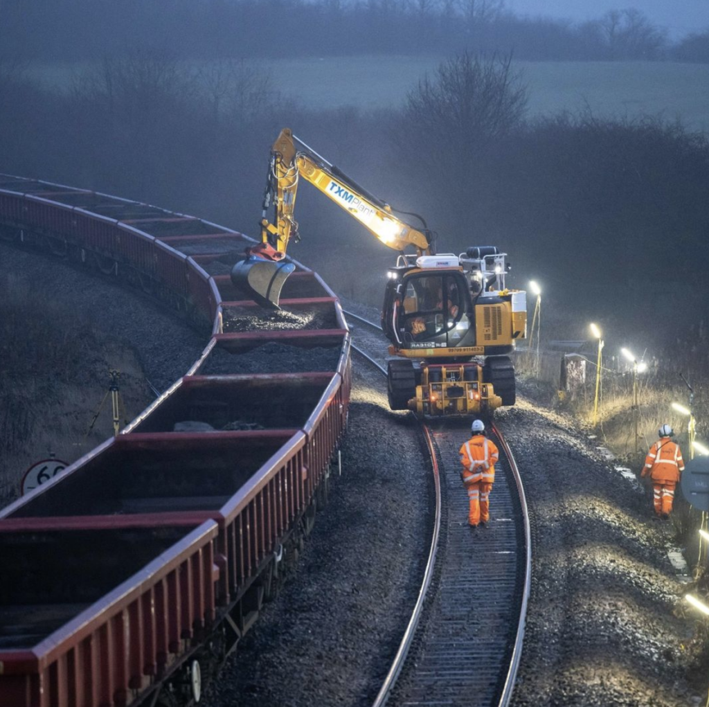 Rail workers out on track next to wagons of ballast during our Easter bank holiday works.