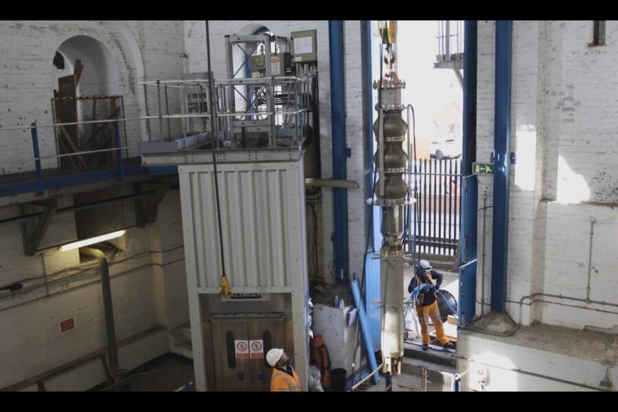 New pump being lifted by crane into pumphouse