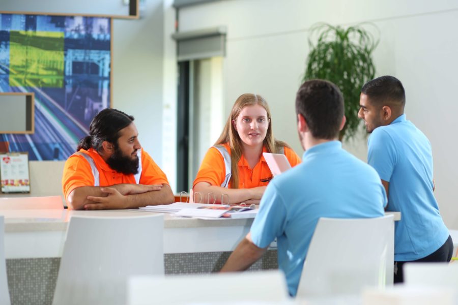 Group of apprentices talking in training centre breakout area