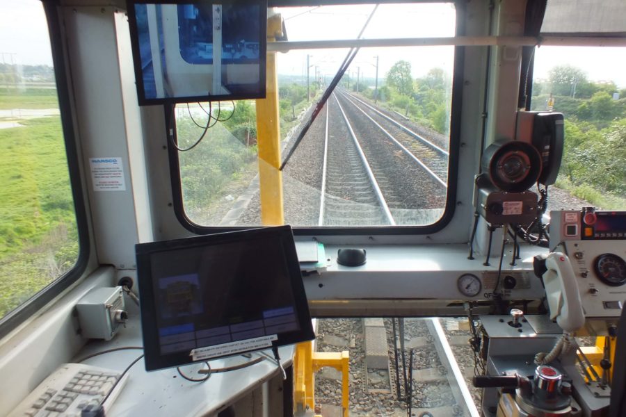 Inside the driver cab of the stoneblower train, looking out onto the tracks