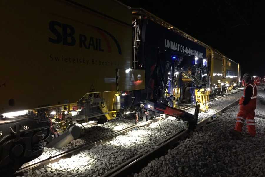 Dynamic Track Stabilisation unit at night time with Network Rail workers
