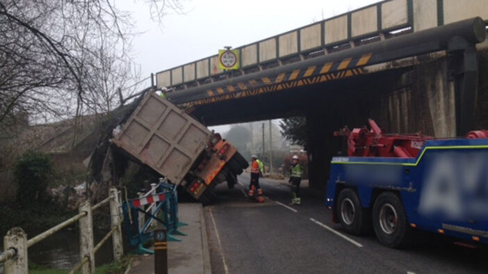 A lorry on it's side after hitting a bridge