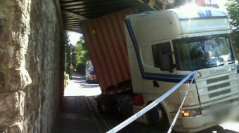 A lorry that has got twisted after crashing into a bridge