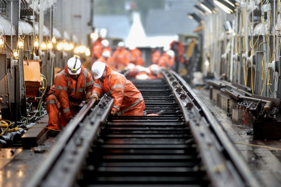 Engineers work on track over a bridge