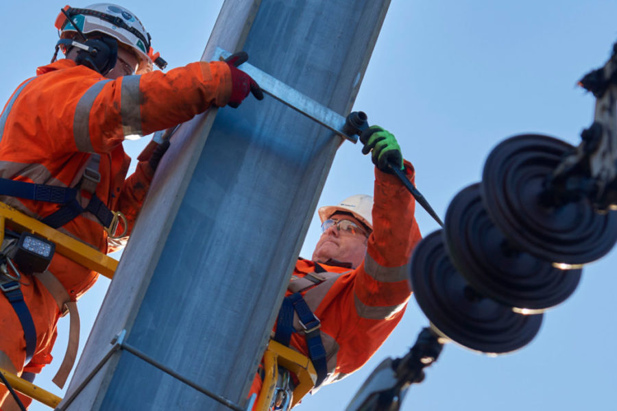 Two engineers working to upgrade the power supply on the East Coast Mainline